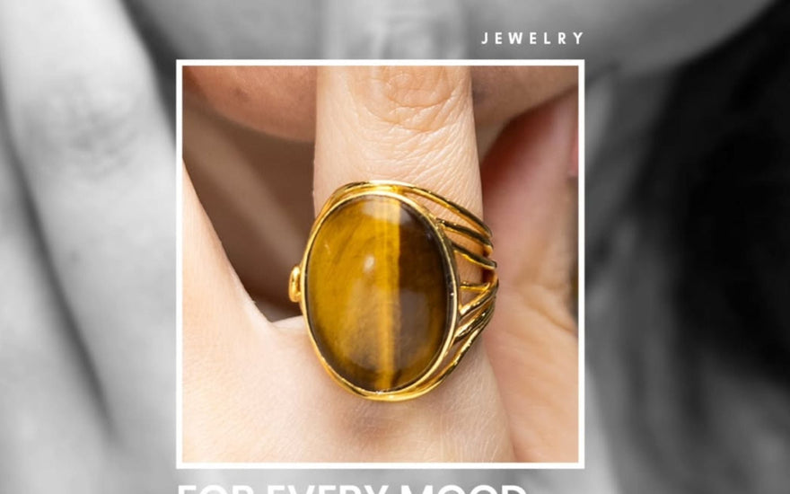 A finger wearing gemstone ring emphasizing on mood and goal related crystal