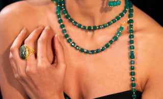 Women wearing gemstone green jewelry necklace, ring, bracelet