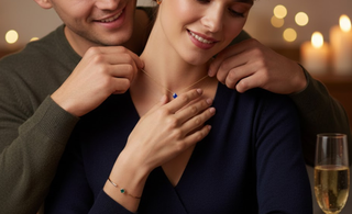 Romantic moment of a couple celebrating anniversary, surrounded by candles, rose petals, and lights—symbolizing love, celebration, and meaningful gemstone jewelry.