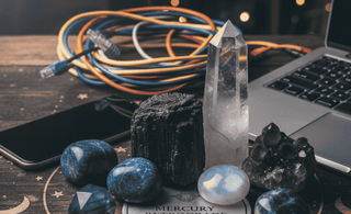 Crystals like clear quartz, sodalite, moonstone etc with Mobile, USB wires and laptop