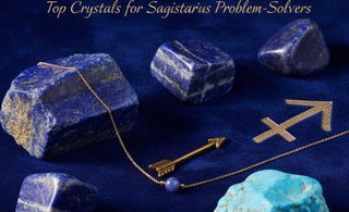 Flat lay of luxurious Sagittarius crystals (Lapis Lazuli, Sodalite, Turquoise) with a gold Stone Story necklace on sapphire blue velvet.
