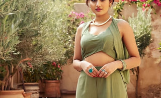 A beautiful girl stand in front of calm flower set up showing the jewelry trend in summer 