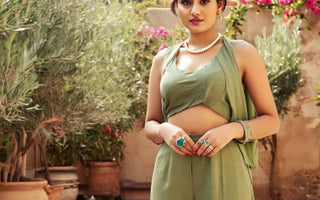A beautiful girl stand in front of calm flower set up showing the jewelry trend in summer 