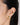 A model wearing round 18k Gold plated 925 sterling silver stud earrings featuring bezel-set clear quartz gemstones and textured edge detailing.