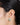 A model wearing circular stud earrings featuring bezel-set peridot gemstones in 925 sterling silver with matte gold, polished gold, and rhodium-plated finishes.