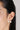 Woman wearing pearl stud earrings in 18K gold plated 925 sterling silver featuring a modern double pearl design.