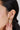 A model wearing Gold-plated 925 sterling silver floral drop earrings featuring peridot and amethyst gemstones with freshwater pearl drops.
