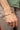 Man wearing personalized men's bracelet in 925 sterling silver with 18K gold plating and custom engraved nameplate on a classic curb chain bracelet.