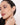 A model wearing 925 sterling silver hoop earrings with alternating black and clear cubic zirconia stones in a sleek pavé setting.