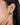 A model wearing Gold-plated 925 sterling silver stud earrings with ruby, sapphire and green onyx gemstones in a contemporary cluster design