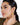 A model wearing Circular shaped hoop earrings featuring bezel-set clear quartz gemstones in 925 sterling silver with 18K gold plating