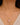 A close-up of a model wearing a delicate chain necklace made in 925 Sterling Silver 18K Gold plated with a small clear stone accent and rose quartz gemstone pendant.