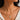 A close-up of a model wearing a delicate chain necklace made in 925 Sterling Silver 18K Gold plated with a small clear stone accent and green amethyst gemstone pendant.