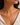 A close-up of a model wearing a delicate chain necklace made in 925 Sterling Silver 18K Gold plated with a small clear stone accent and green amethyst gemstone pendant.