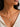 A close-up of a model wearing a delicate chain necklace made in 925 Sterling Silver 18K Gold plated with a small clear stone accent and green amethyst gemstone pendant.