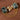 Gold-plated 925 sterling silver brooch featuring natural seraphinite gemstones, a snake motif with sparkling accents, and layered chain details.