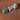 925 sterling silver brooch featuring natural seraphinite gemstones, pavé accents, and cascading chain details.