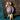 Gold-plated bird brooch featuring a natural charoite gemstone body and amethyst accent.