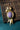 Gold-plated bird brooch featuring a natural charoite gemstone body and amethyst accent.