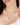Natural emerald halo pendant necklace in 18K gold plated 925 sterling silver worn by a model.