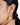 A model wearing Circular shaped hoop earrings featuring bezel-set clear quartz gemstones in 925 sterling silver with 18K gold plating