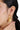 A model wearing Circular shaped hoop earrings featuring bezel-set clear quartz gemstones in 925 sterling silver with 18K gold plating