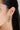 a model wearing Hexagon drop hoop earrings featuring bezel-set peridot gemstones in 925 sterling silver with rhodium plating