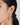 A model wearing Circular shaped hoop earrings featuring bezel-set clear quartz gemstones in 925 sterling silver with rhodium plating