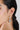A model wearing Circular shaped hoop earrings featuring bezel-set clear quartz gemstones in 925 sterling silver with rhodium plating