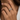 A close-up of a woman's hand wearing stack of three slim eternity rings. The rings feature alternating rows of pave band ring made in 925 sterling silver finished in 18K Gold, Rose Gold and rhodium
