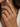 A close-up of a woman's hand wearing stack of three slim eternity rings. The rings feature alternating rows of pave band ring made in 925 sterling silver finished in 18K Gold, Rose Gold and rhodium
